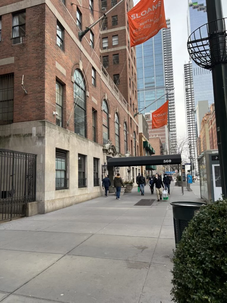 BlueGround Apartment Exterior: Exterior of the BlueGround apartment building, showing a modern urban facade with a secure entrance and doorman amenities.
