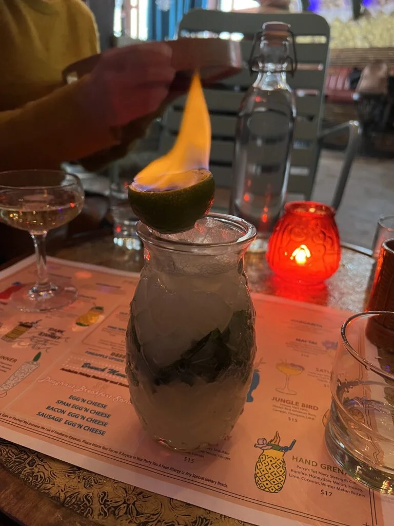 Flaming tropical cocktail in a vintage glass at Tiki Chick