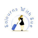 Logo of 'Sojourns With Sue' featuring a stylized illustration of a woman in a black dress pulling a blue suitcase, encircled by the blog's name.