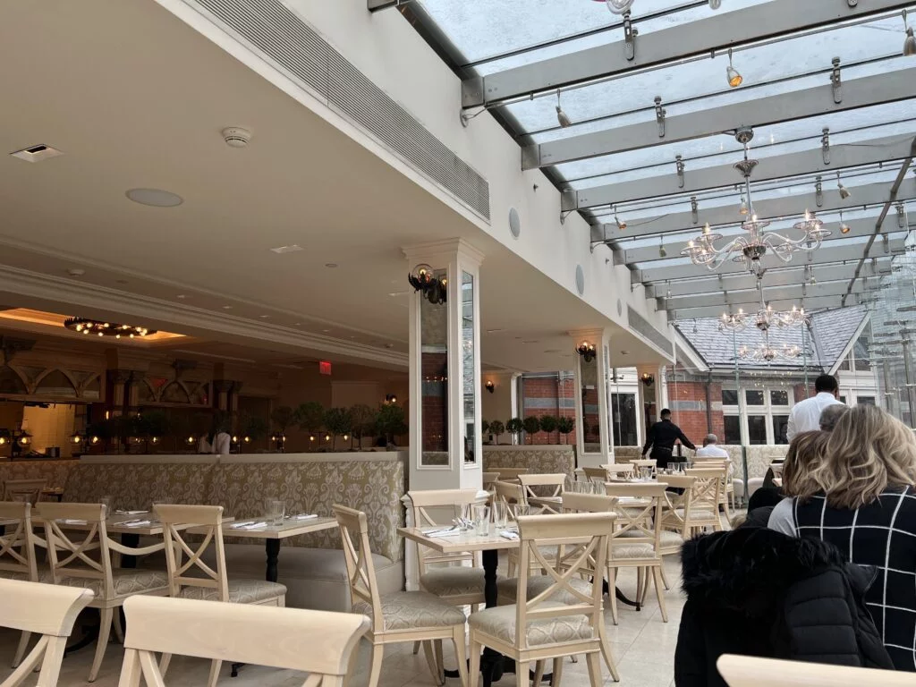 Greenhouse-style atrium seating with natural light at Tavern on the Green