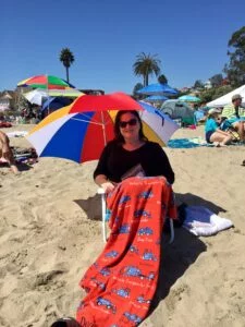 Cinque Terre in One Day: Easy Itinerary for First-Timers 1 Sue lounging on Capitola beach, covered from head to toe