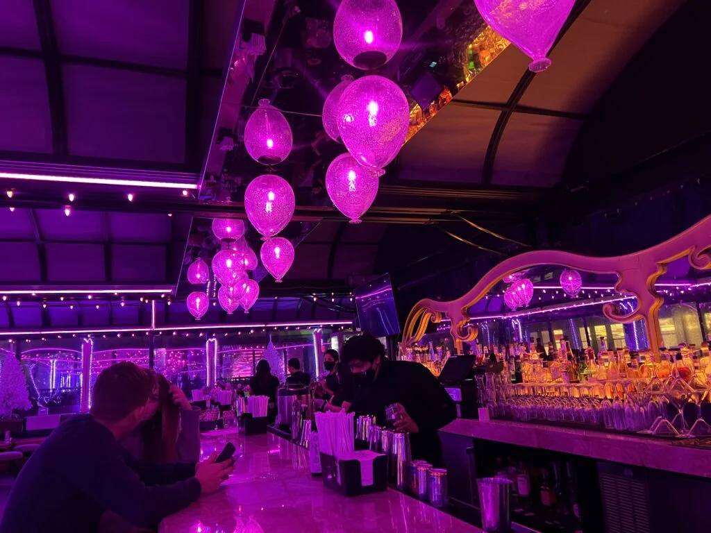 Balloon-style pink lights over rooftop bar at Magic Hour NYC.