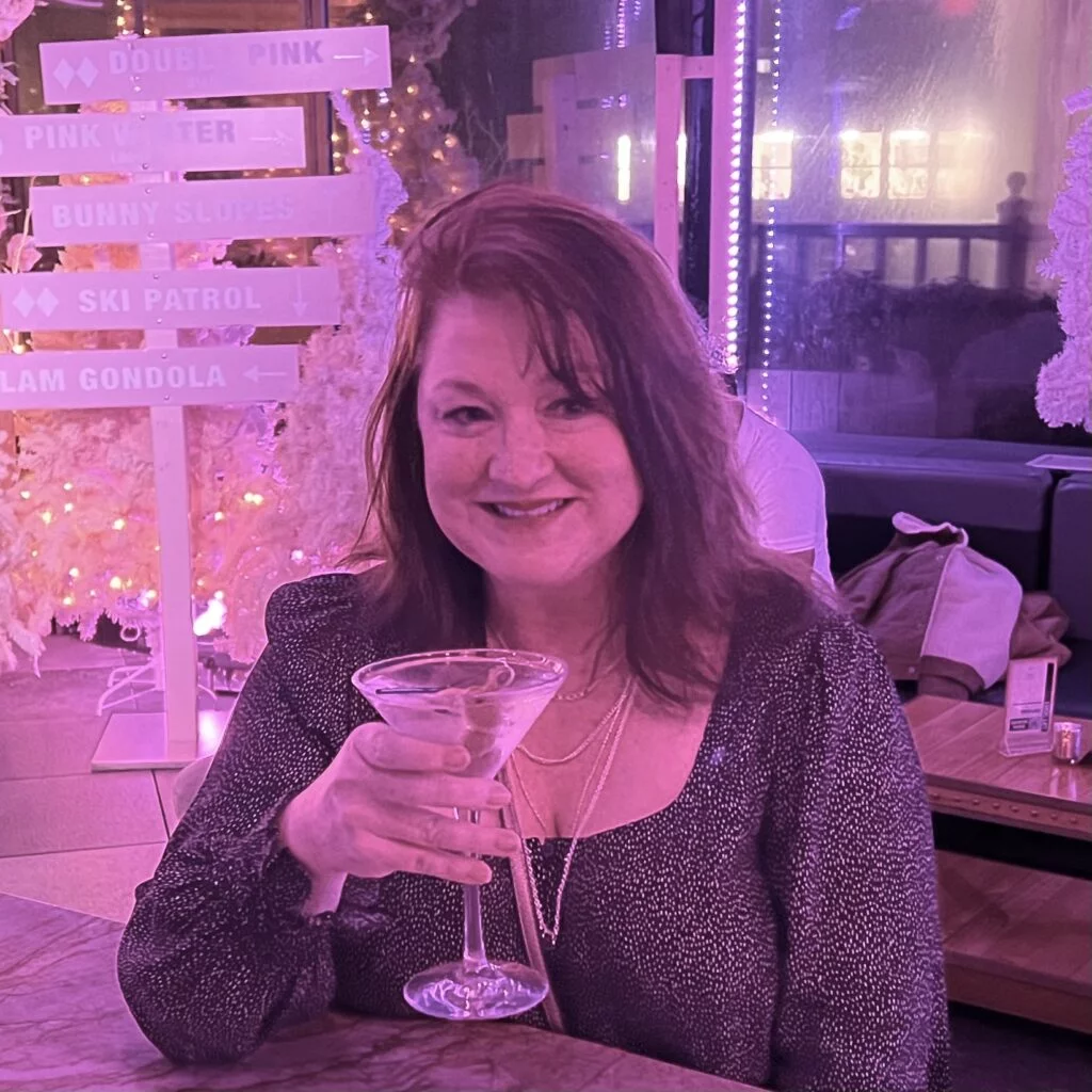 Pink-lit bar at Magic Hour Rooftop with view of Empire State Building.