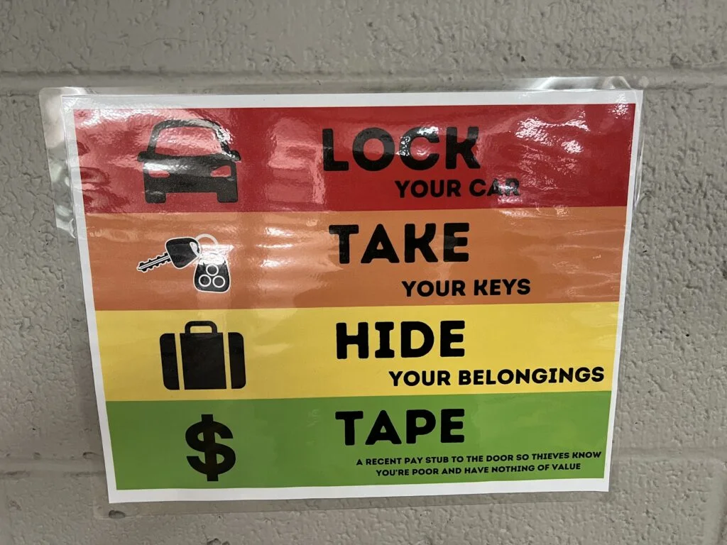 A funny helpful tip written on a sign in the hostel's parking lot.