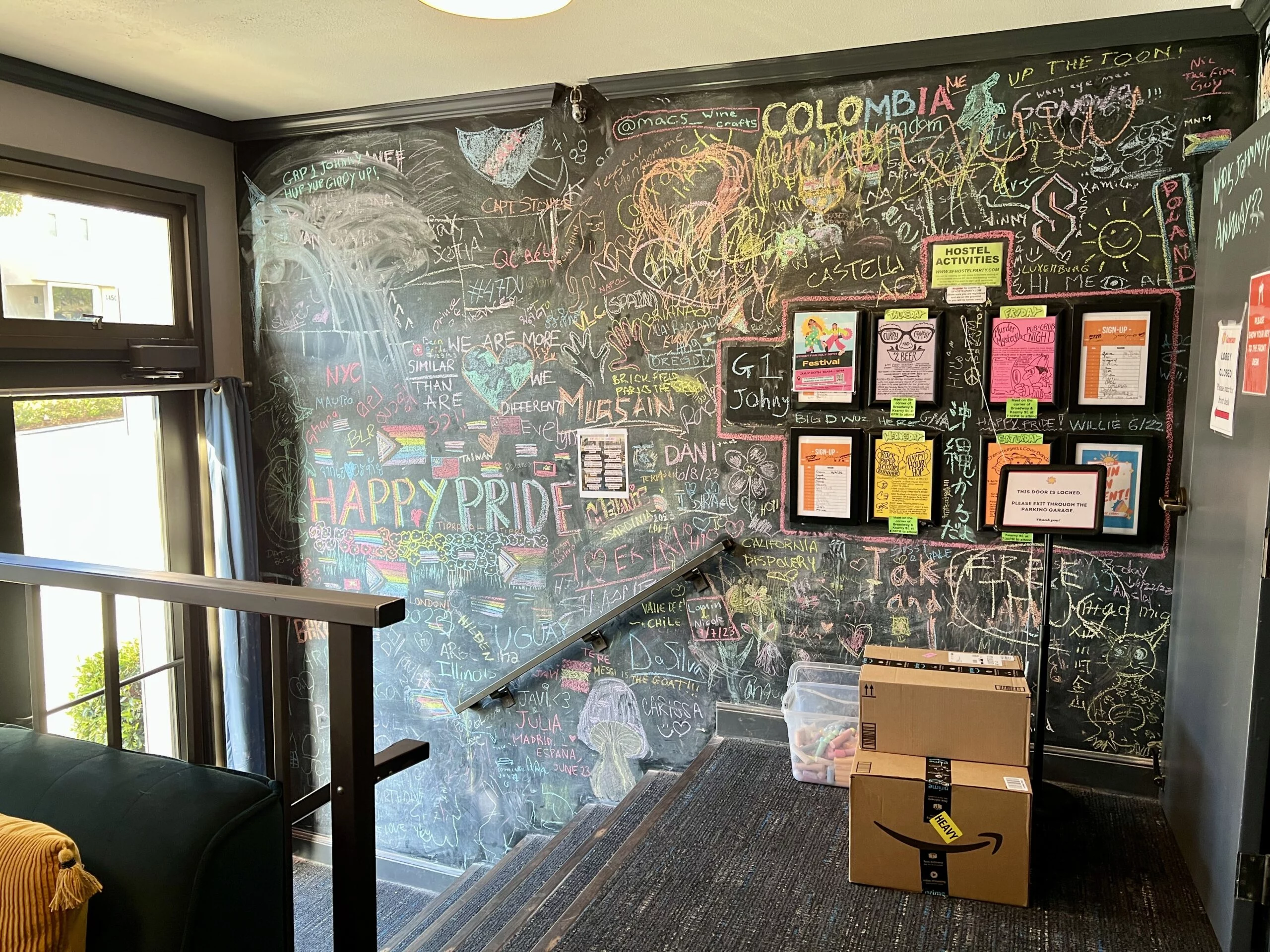 A chalkboard in the hostel lobby with travel information.
