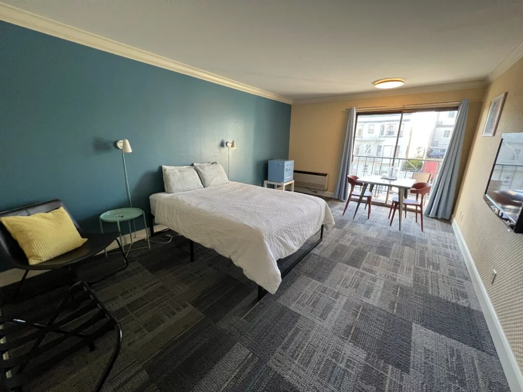 Interior of a private room with a double bed in Samesun Hostel.
