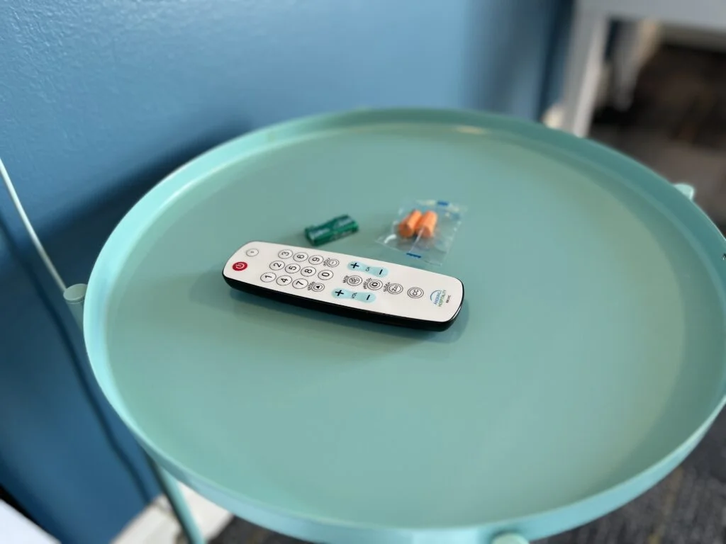 Complimentary chocolate mints and earplugs on the bedside table.