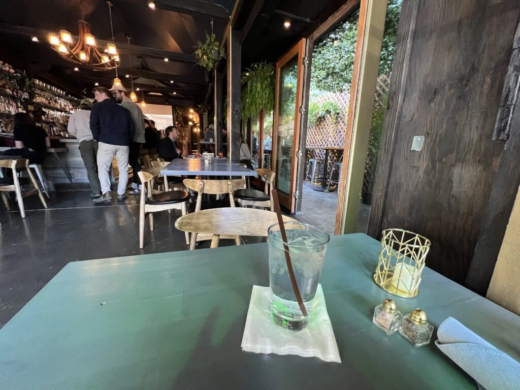Interior of Trinity Irish Bar & Restaurant with outdoor seating visible.