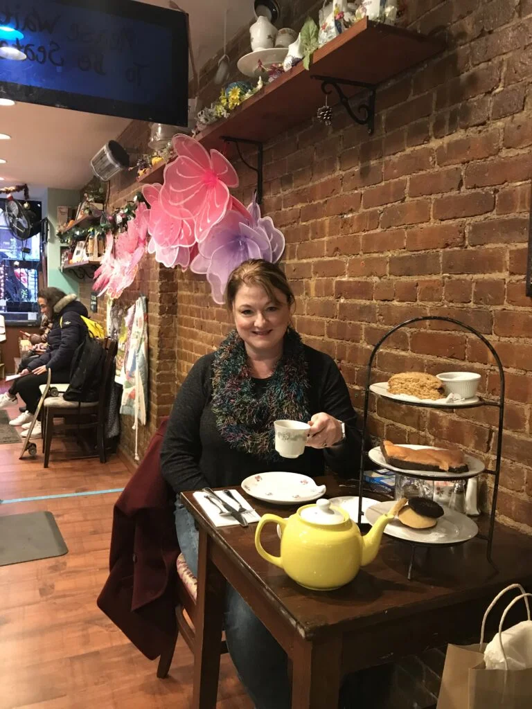 Fairy-wing decor and bookshelves inside Alice’s Tea Cup