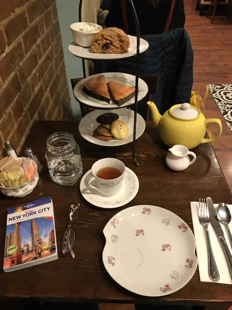 Scone and tea service on mismatched china at Alice’s Tea Cup, New York City.