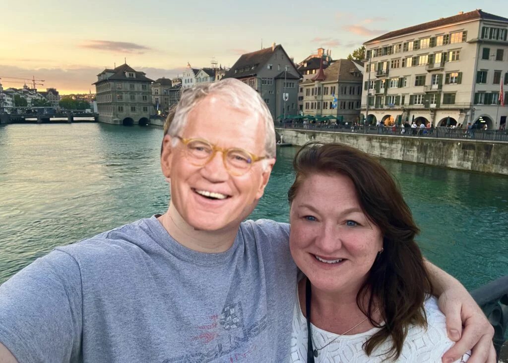Zurich Old Town Evening Stroll: A serene evening scene in Zurich's Old Town, with illuminated historic buildings lining the cobblestone streets near the Limmat River.