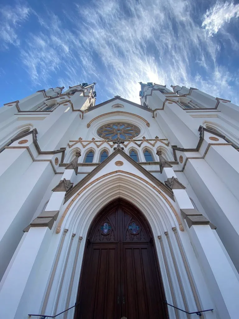 Captivating low angle shot of the  Neo-Gothic exterior of the Cathedral of St. John the Baptist in Savannah, Georgia.