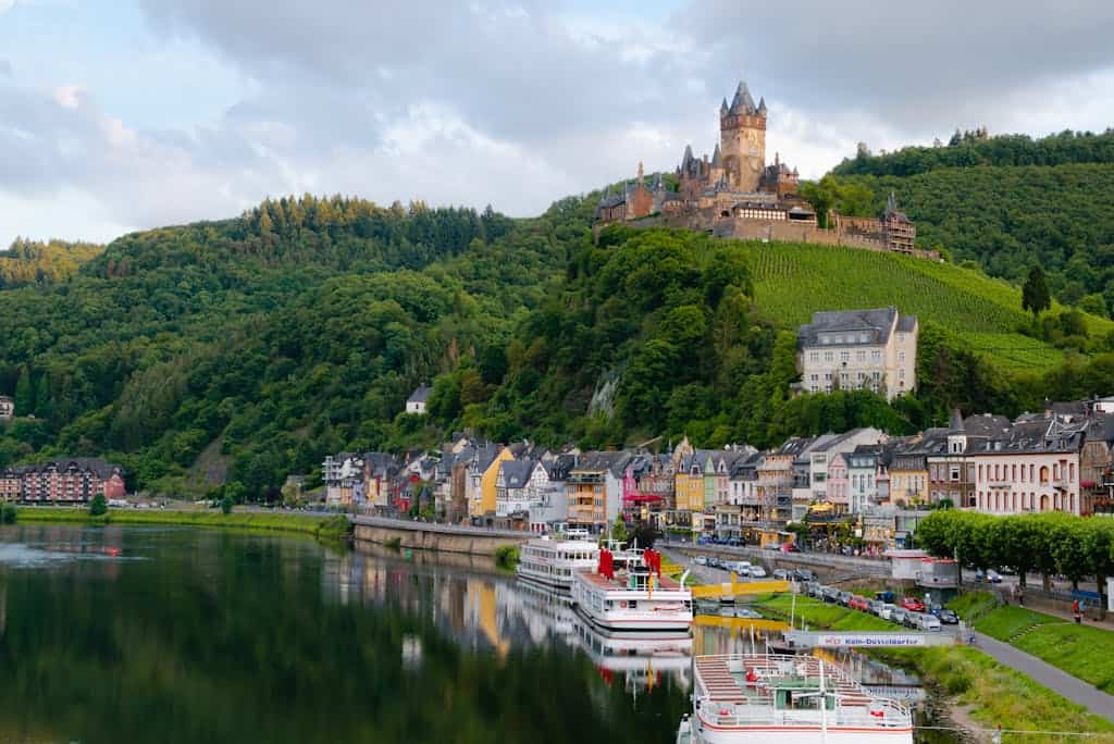 Cool Places to Stay Around the World: Travel Bloggers Share Their Favorites 3 Idyllic landscape of Cochem Castle overlooking Moselle River in Germany.