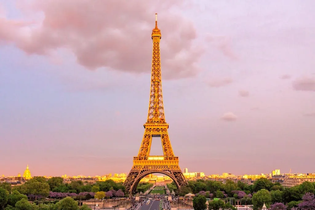 Europe 4 Capture of the Eiffel Tower in Paris at dusk with a vibrant sky, showcasing its iconic structure.