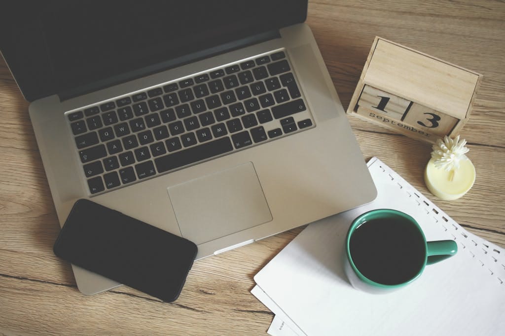 10 Travel Lessons I Just Learned in Europe (and What I’ll Do Differently Next Time) 8 Modern office desk setup with laptop, smartphone, coffee, and calendar for productive work environment.