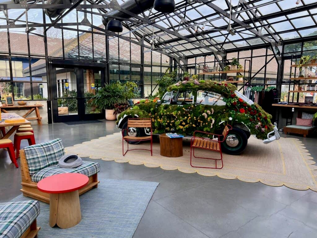 Treehouse Hotel Silicon Valley lobby with a Volkswagen Beetle covered in foliage