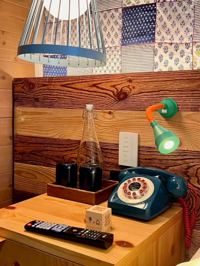I Stayed at the Treehouse Hotel Silicon Valley. Here's the Truth. 10 Treehouse Silicon Valley bedside table with old timey telephone and reading lights