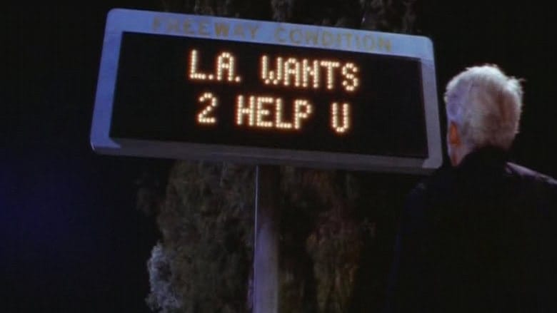 Steve Martin looks at a freeway sign in the movie L.A. Story