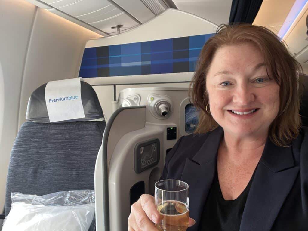 I Sat Next to a Stranger on a Flight. Now I Might Own Part of a Paris Apartment. 1 Woman with champagne on an airplane
