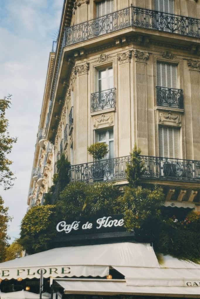 I Sat Next to a Stranger on a Flight. Now I Might Own Part of a Paris Apartment. 3 Elegant facade of Cafe de Flore, iconic historic café in Paris, France, known for its classic architecture and rich history.