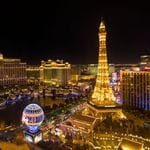 Stunning nighttime aerial view of the Las Vegas Strip featuring the Eiffel Tower replica.