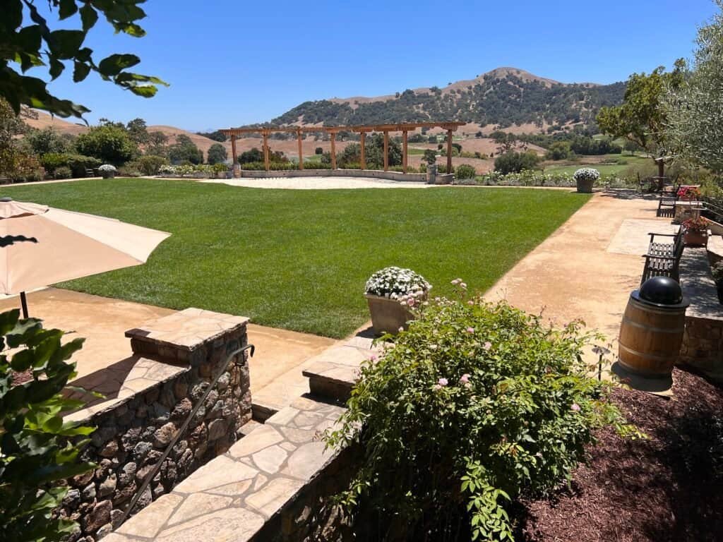 CordeValle Winery Isn't What I Thought It Was 4 The crescent lawn at CordeValle Winery with vineyard and hill views