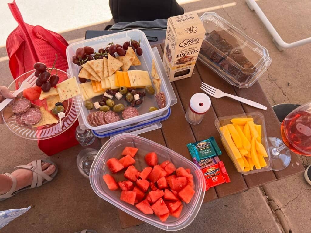 Cabana table covered with sushi rolls, fruit, brownies, and drinks