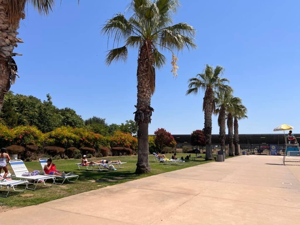 Open grass area beside the pool deck at the Morgan Hill Aquatics Center