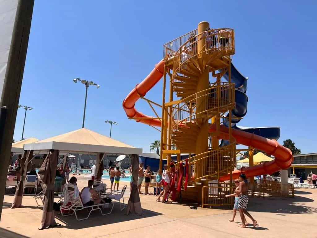 Water slide tower and stairs seen from the cabanas at the Morgan Hill Aquatics Center